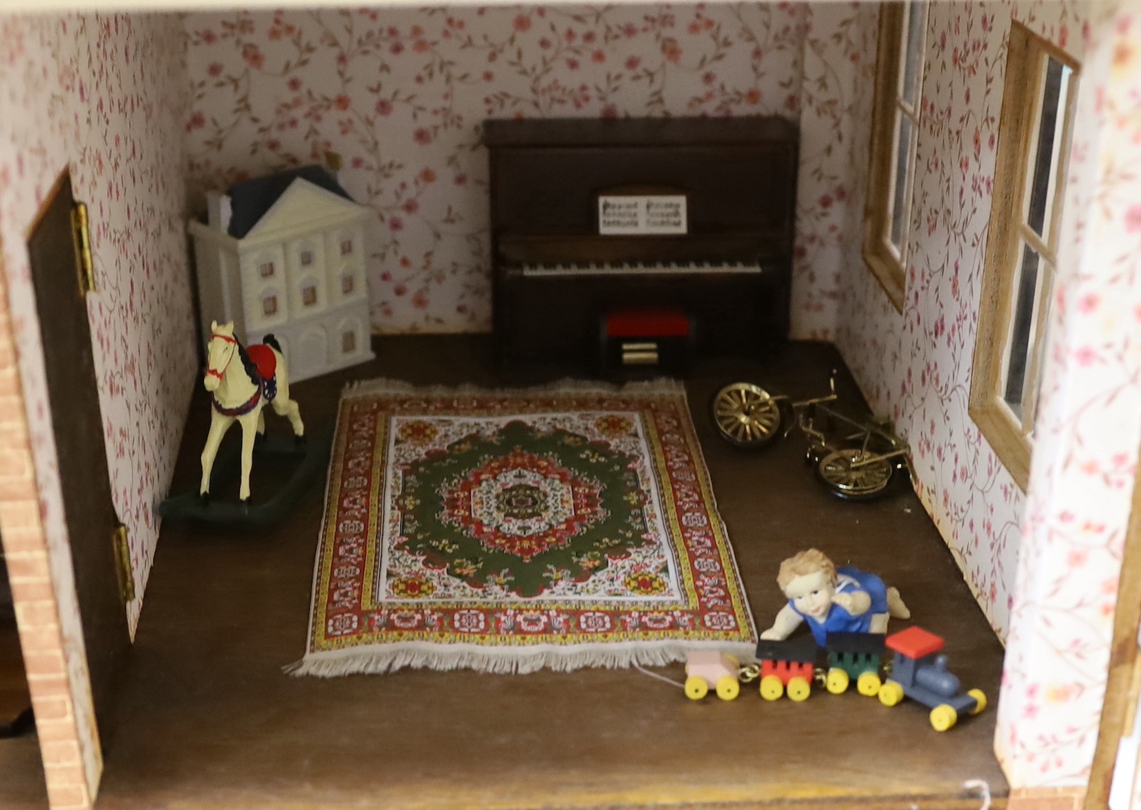 A mid 20th century doll's house and contents, 84cms x 100cms high